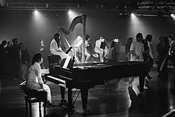 a pianist, a harpist and other musicians