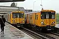 Merseyrail Class 507 and Class 508 units pass at the station.