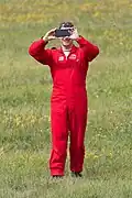 Pilots of the Red Arrows wear red flying suits.