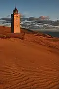Lighthouse being encroached by the sand dunes