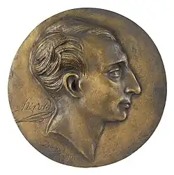 bronze medallion with young man's face in right profile