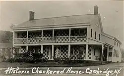 Old postcard of the Checkered House in Cambridge, NY, painted with checkers in 1853 and burned 7 February 1907