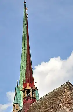 The 27.1 metres (88.9&nbsp;ft) high ridge turret of Predigerkirche Zürich, its 96 metres (315&nbsp;ft) clock tower in the background.