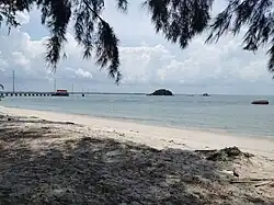 White sandy beach in Besar Island near the jetty, overlooking Lalang Island.