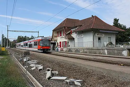 Two side platforms next to two-story station building