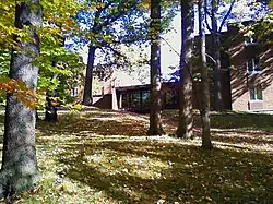 Picture of a building with trees (leaves turning) in the foreground. Ravine Hall is a coed residence hall currently housing students of all class years