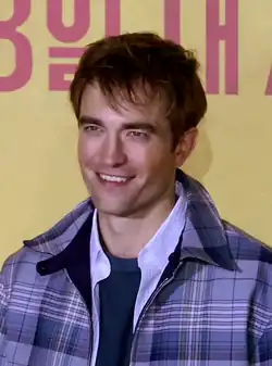 Pattinson looking to his front while smiling