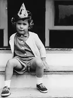 Black-and-white photographic portrait of Bush sitting on porch steps