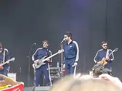 Eels onstage, wearing track suits