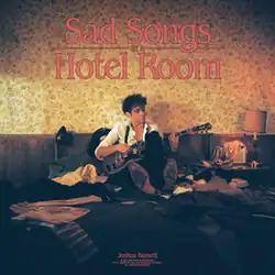 Cover artwork for the EP Sad Songs in a Hotel Room depicting Joshua Bassett playing guitar while sitting on a messy bed in a hotel room with a beige patterned wallpaper. The EP title is written in a red font on the top center