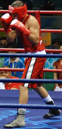 photograph of Said Rachidi boxing in the ring at the Olympics
