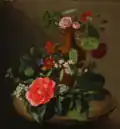 Roser, slyngplanter og andre blomster i en vase på et bord, c. 1877