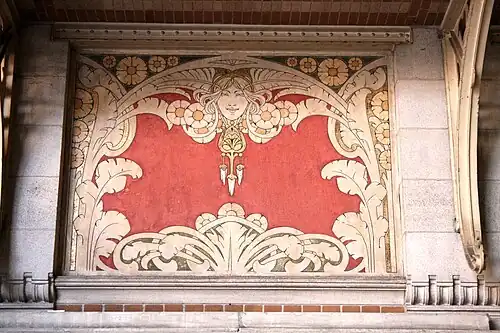 Art Nouveau sgraffito mascaron of the Groupe scolaire Josaphat (Rue de la Ruche no. 30), Schaerbeek, Belgium, architect Henri Jacobs, sgraffito by Privat Livemont, 1907[48]