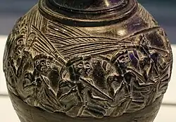 The men in front of the sistrum player