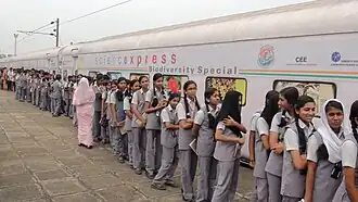 Students queue outside the train in 2014