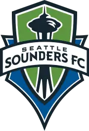 The Seattle Sounders FC crest, with the team's name on a banner stretched across a green and blue shield with the shape of the Space Needle in the center.