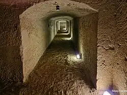 Photograph of a low limestone corridor