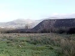 Slate tips on outer edges of Penrhyn Quarry at Mynydd Llandegai, with Bethesda in the distance