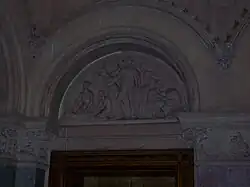 Carved stone tympanum showing enslaved African cotton pickers overseen by ominously depicted slave master