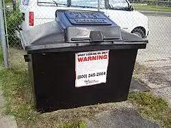A large bin, with "GREASE ONLY" stamped on the lid.