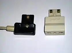 Magic Security plug (10&nbsp;A) (left) with a type L to Magic Security plug adaptor