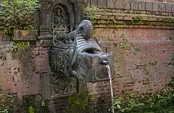 Yaksha beneath the spout of Bhimsen Hiti, Bhaktapur