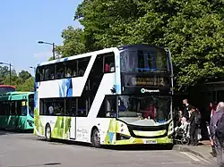 Right side photograph of white, green and blue Volvo BZL double-decker bus
