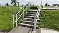 A flight of stairs leading to an elevated burial plot at the cemetery.