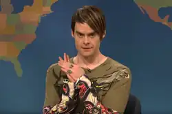 The character Stefon, portrayed by Bill Hader, with brown side-swept hair and a tattoo patterned Ed Hardy shirt, on Weekend Update