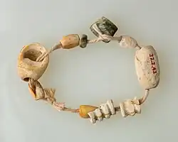 String of beads; 4400–3800&nbsp;BC; the beads are made of bone, serpentinite and shell; length: 15&nbsp;cm; Metropolitan Museum of Art