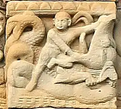 Hero with headband wrestling a Makara.