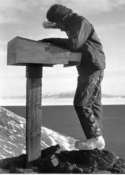 Mariner from the USNS Southern Cross signs the summit registry