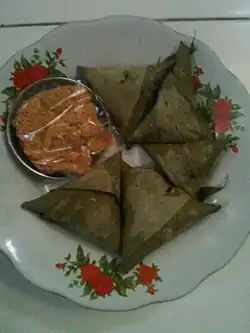 Kupat sumpil, a triangular ketupat wrapped in bamboo leaves