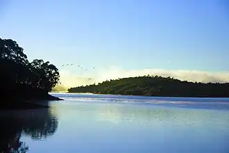 Sunrise over the calm waters of Lake Mantasoa