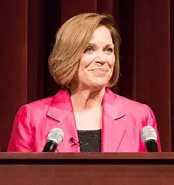 Swain standing behind a podium