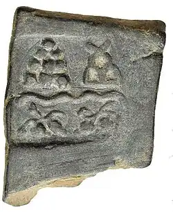 Taxila single-dye coin. Pile of stones, hill, river and unknown symbols (220–185 BCE).