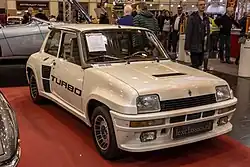 A small rear-mid-engined car with three doors