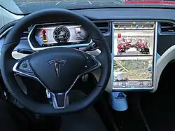 The steering wheel, dashboard, and touchscreen of a Model S