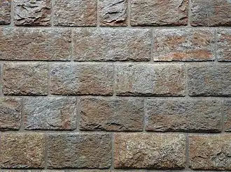 A wall of bricks with raised areas