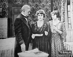 Vintage movie lobby card showing film title and cast names with dramatic scene