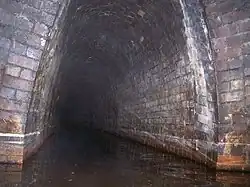 The Butterley Reservoir adit where it enters the Butterley Tunnel about 600 yards (550&nbsp;m) along the tunnel from the western portal in 2006