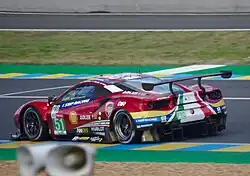 A cherry red Ferrari 488 GTE Evo as viewed from a near side angle