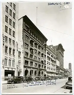 Black and white image of a downtwon street scene centered on a six-storey office building