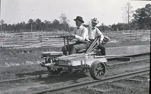3-wheeled Sheffield velocipede[9] on a railroad track. It is operated by hand, pumped by the arms in a back-and-forth rowing motion.