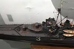 Forward 130 mm guns in superfiring single mounts 130 mm (5.1 in) Mle 1919 guns, main telemeter and searchlights on top of the bridge