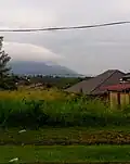 The Titiwangsa Mountains near Rembau, looking south. Mount Tampin is recognizable as the light grey triangular mountain rising behind Mount Datuk (cloud-capped peak in the foreground).