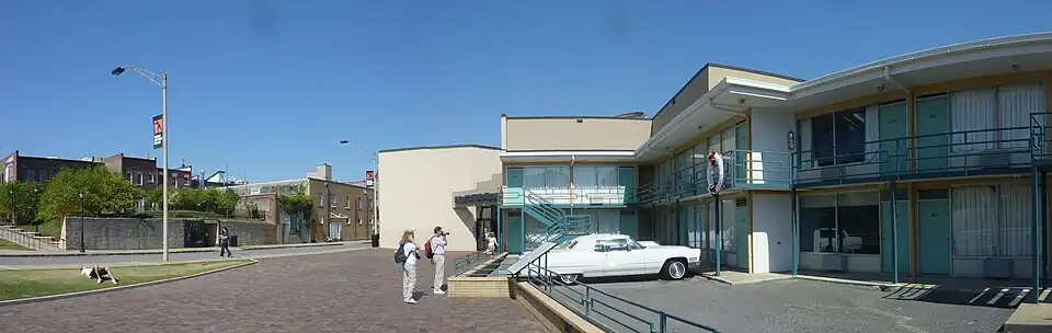 Wide view of the Lorraine Motel and the boarding house from which James Earl Ray assassinated King from (shown to the left of the light pole).