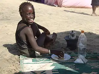 Gambian child enjoying making Attaya