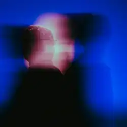 The image depicts blurry silhouettes of the band members (from left to right: Ross and Rocky Lynch). The background is a vivid dark blue with a pinkish light behind them.