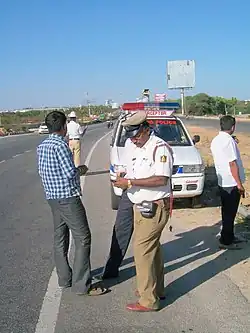 Traffic Sub-Inspector of Police with Interceptor using Black Berry phone for vehicle and driver records
